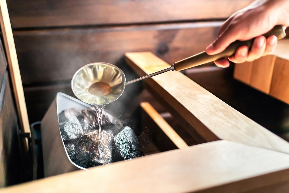 pouring water on the sauna rocks