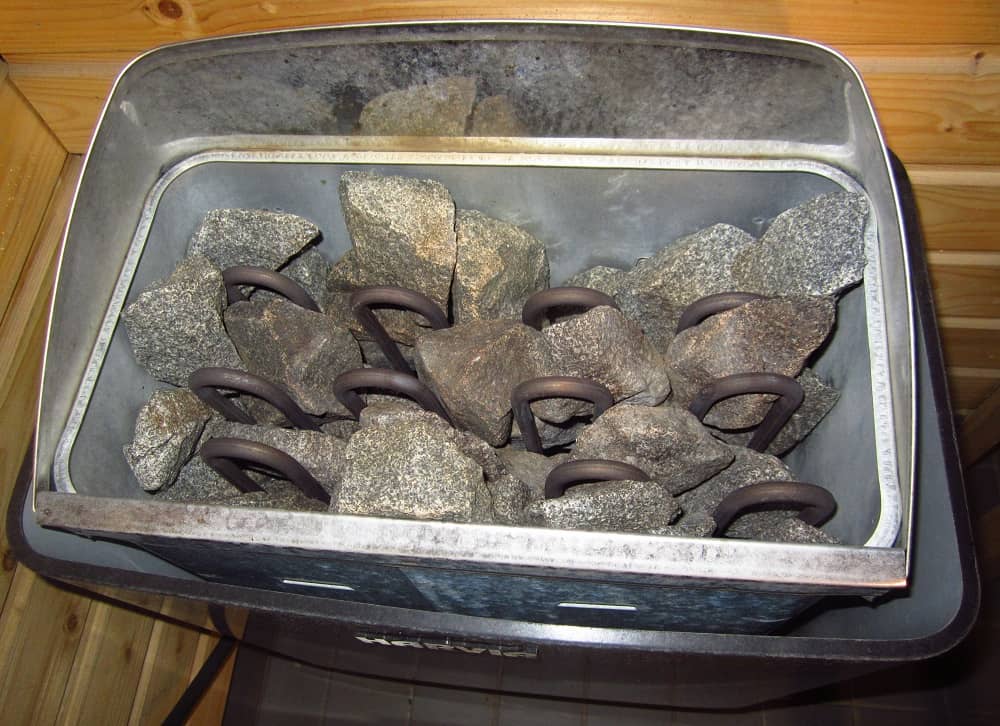 sauna rocks in between heating elements in an electric sauna heater