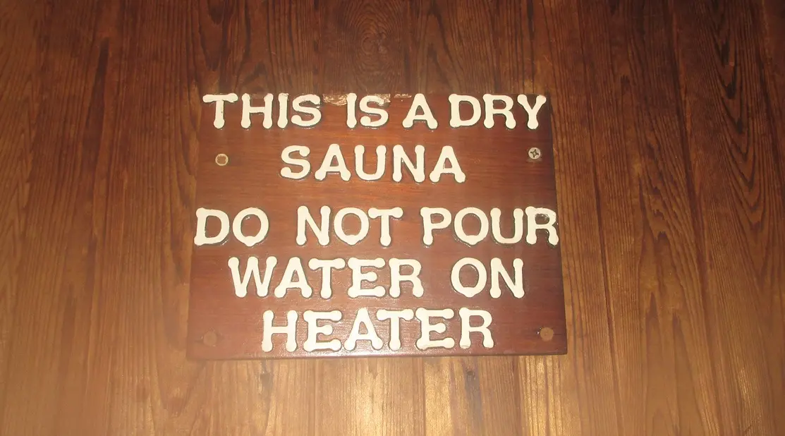 sign on a sauna wall prohibiting pouring water on heater